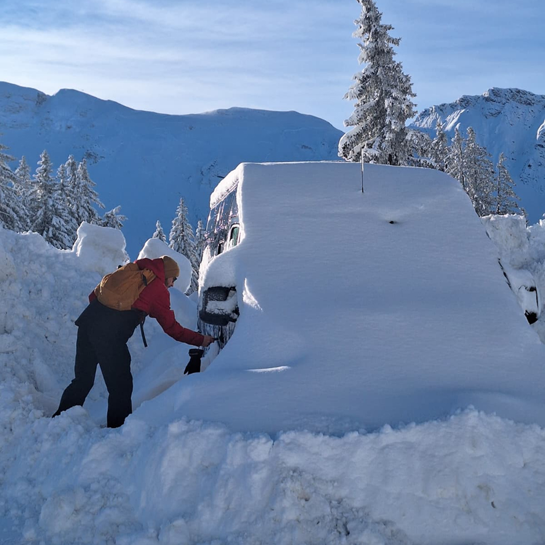 Charlie unlocking snow covered van in Avoriaz France surrounded by snowy trees in winter 2026