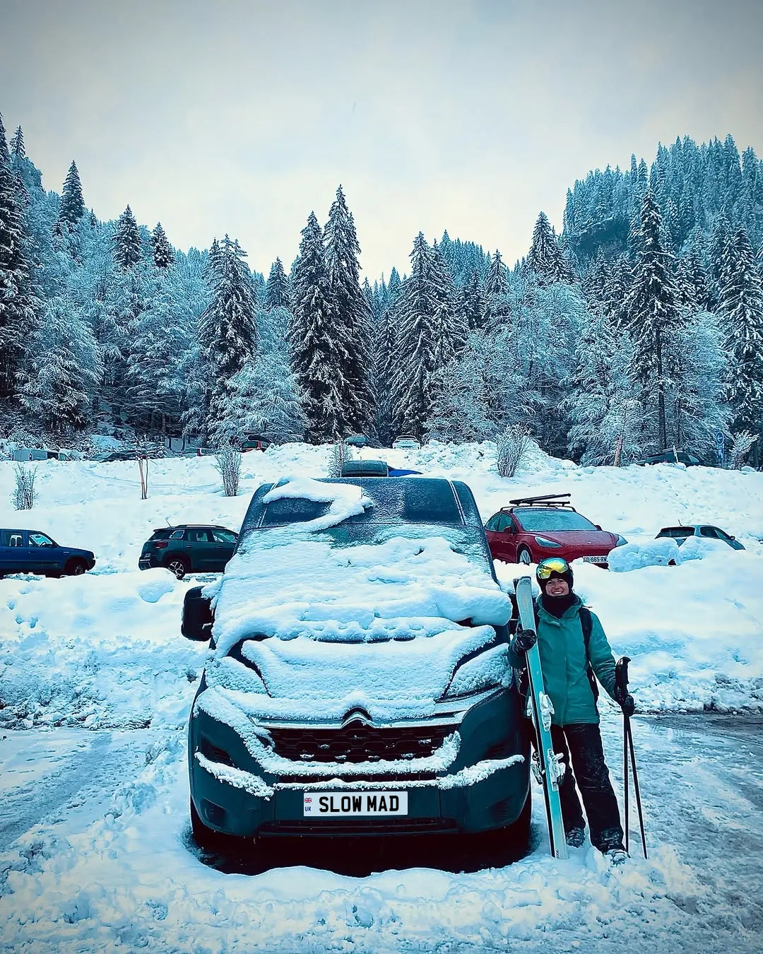 Photo Emily with the van in a ski resort — Winter Van Life